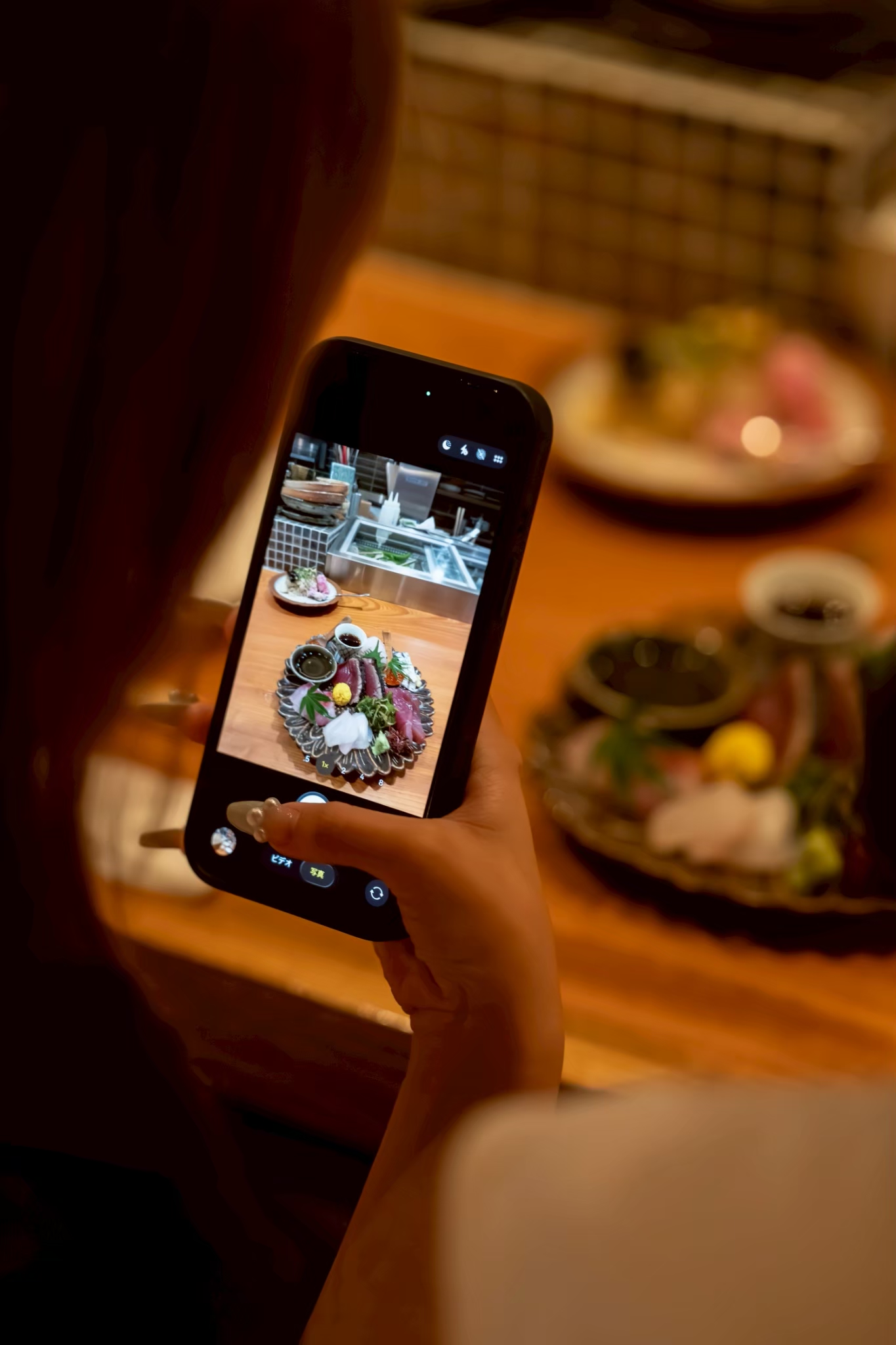 料理を写真に収めるお客様